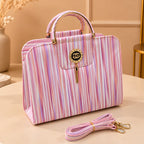 Chic striped structured handbag with gold hardware and tassel charm