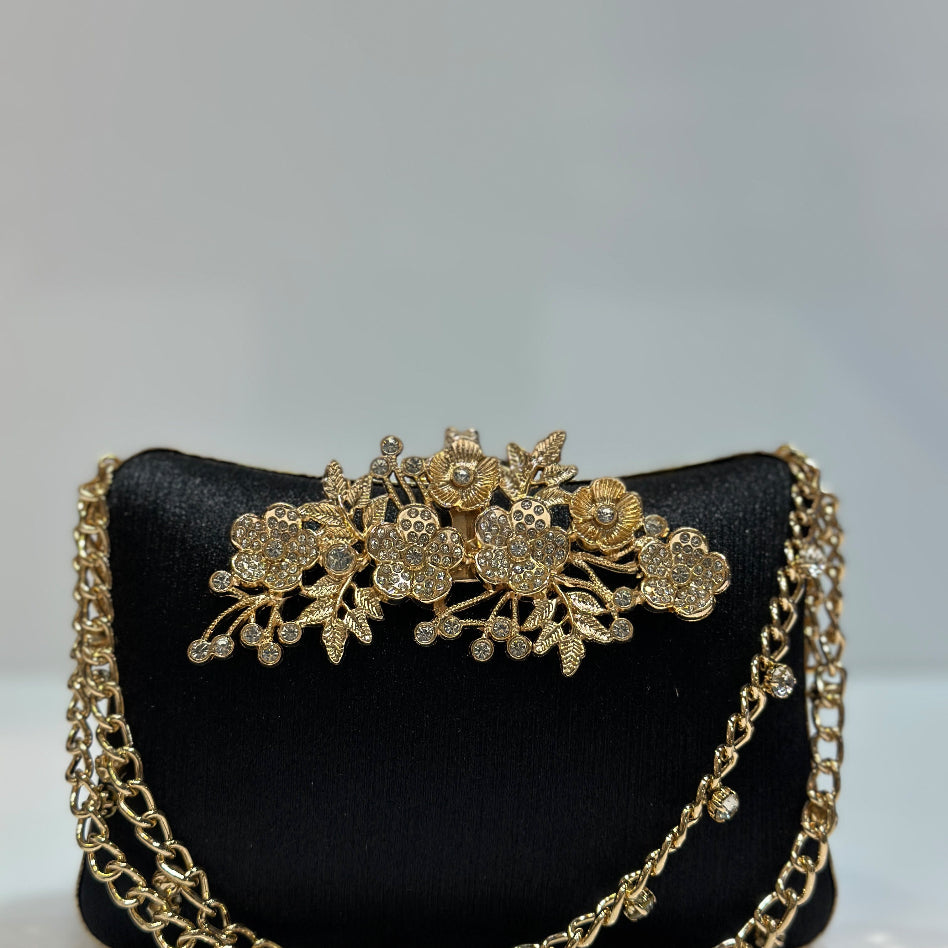 Close-up of the flower-inspired rhinestone clasp on an elegant clutch
