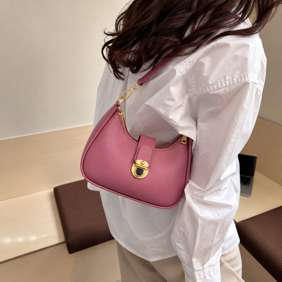 Curved hobo shoulder bag with front lock and gold hardware