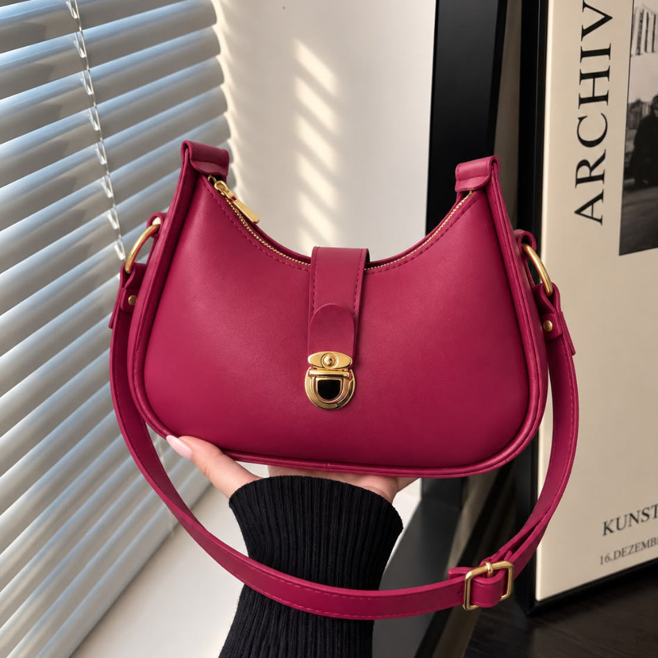 Curved women's handbag with stylish gold hardware