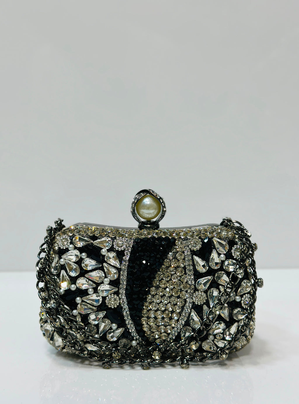 Elegant crystal embellished bridal clutch with pearl clasp