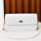 Elegant glossy shoulder bag with decorative chain strap