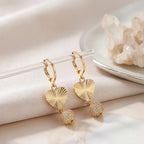 Elegant gold heart earrings with sparkling crystal sphere