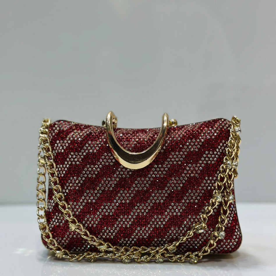 Elegant gold rhinestone handbag with a sturdy top handle and detachable chain strap