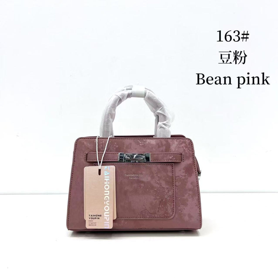 Front view of floral printed women's handbag with front pocket
