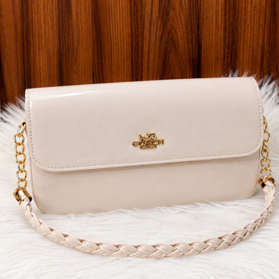 Glossy patent-style handbag with braided chain detail