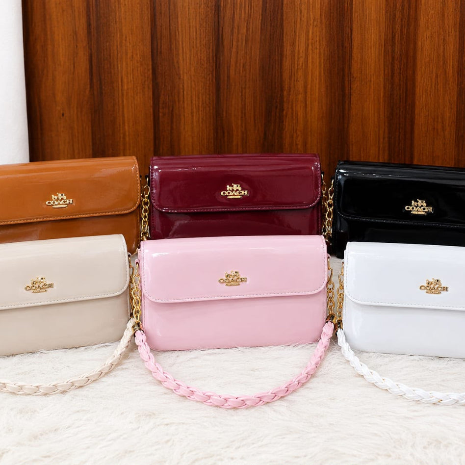 Glossy patent flap shoulder bag with braided chain strap by Rivaalane