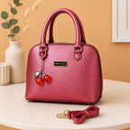 Trendy pink metallic top handle crossbody bag with cherry pendant charm