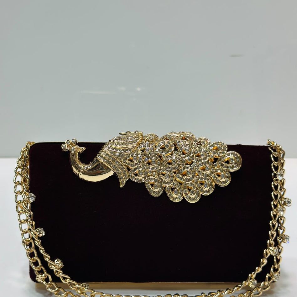 Peacock-inspired party clutch with shimmering finish and rhinestone chain