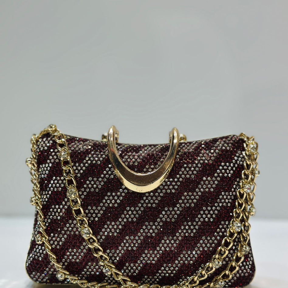 Shimmering rhinestone embellished party purse with a solid gold metal top handle and chain shoulder strap.