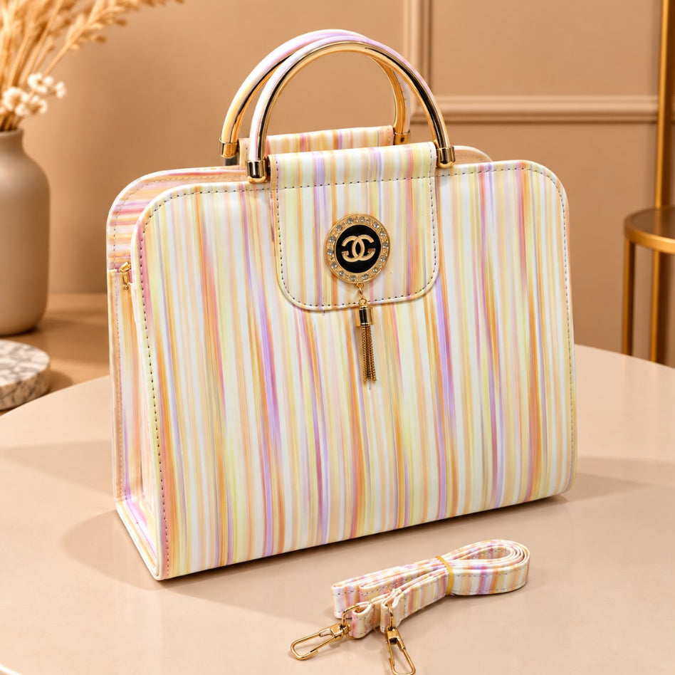 Structured fashion handbag with decorative tassel charm