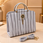 Women's striped handbag with elegant gold-tone hardware
