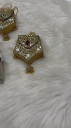 Hanging jhumka-inspired tassel detail on a traditional potli