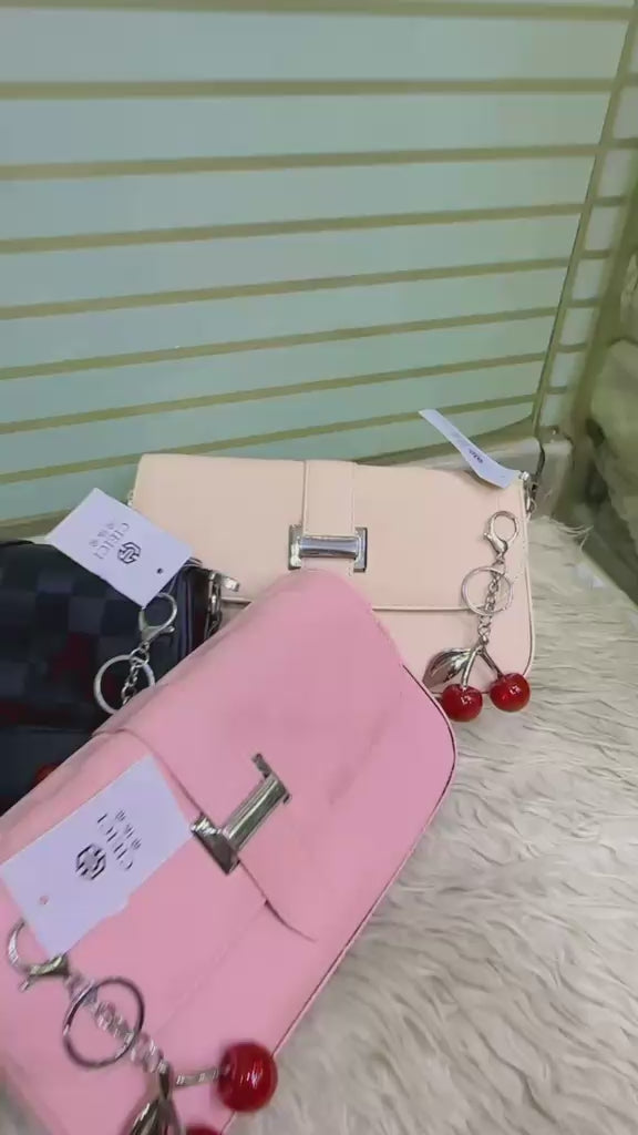 Cherry keychain detail on a women's fashion handbag